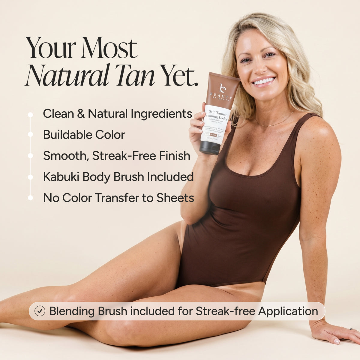 A woman in a brown bodysuit sits on a beige studio background holding a bottle of self tanner tanning lotion. Large text reads 'Your Most Natural Tan Yet.