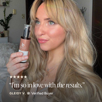 A woman with long blonde hair holds a bottle of Face Serum in front of her face. The image includes a five-star rating graphic and the text: 'I'm so in love with the results.