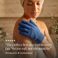 A woman wrapped in a towel wears a blue textured exfoliating glove on her shoulder in a warm spa-like setting. A quote from Michelle B.