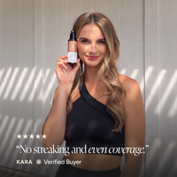 A woman in a black one-shoulder top holds up a bottle of bronzing face mist. Text at the bottom reads, 'No streaking and even coverage.