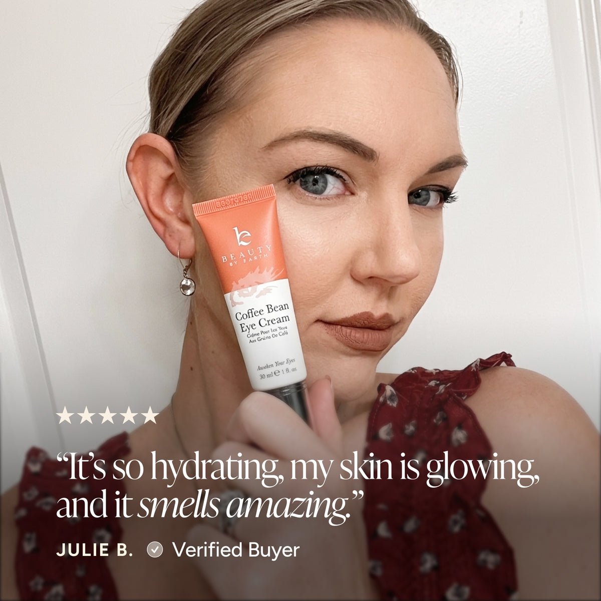 A woman holds a tube of Beauty by earth Coffee Bean Eye Cream next to her face, with a five-star rating and a customer testimonial overlay at the bottom.