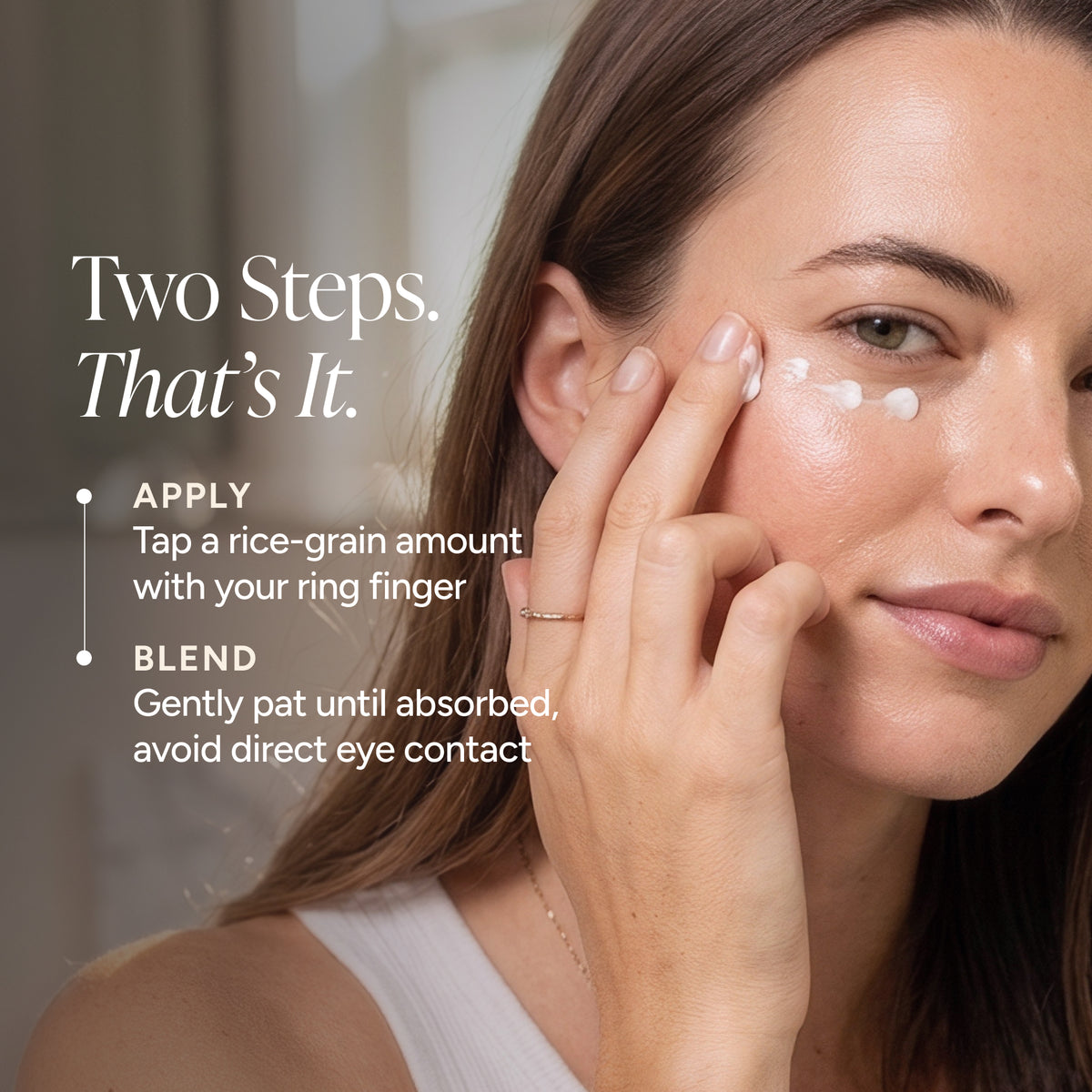 Close-up of a woman applying a white cream to her under-eye area with text reading 'Two Steps. That's It.