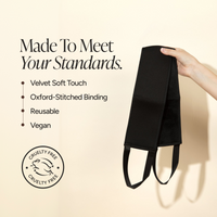 A back applicator held by a hand against a warm beige background, with marketing text listing features such as velvet soft touch, Oxford-stitched binding, reusable use, and vegan material. A circular cruelty-free logo appears in the lower left.
