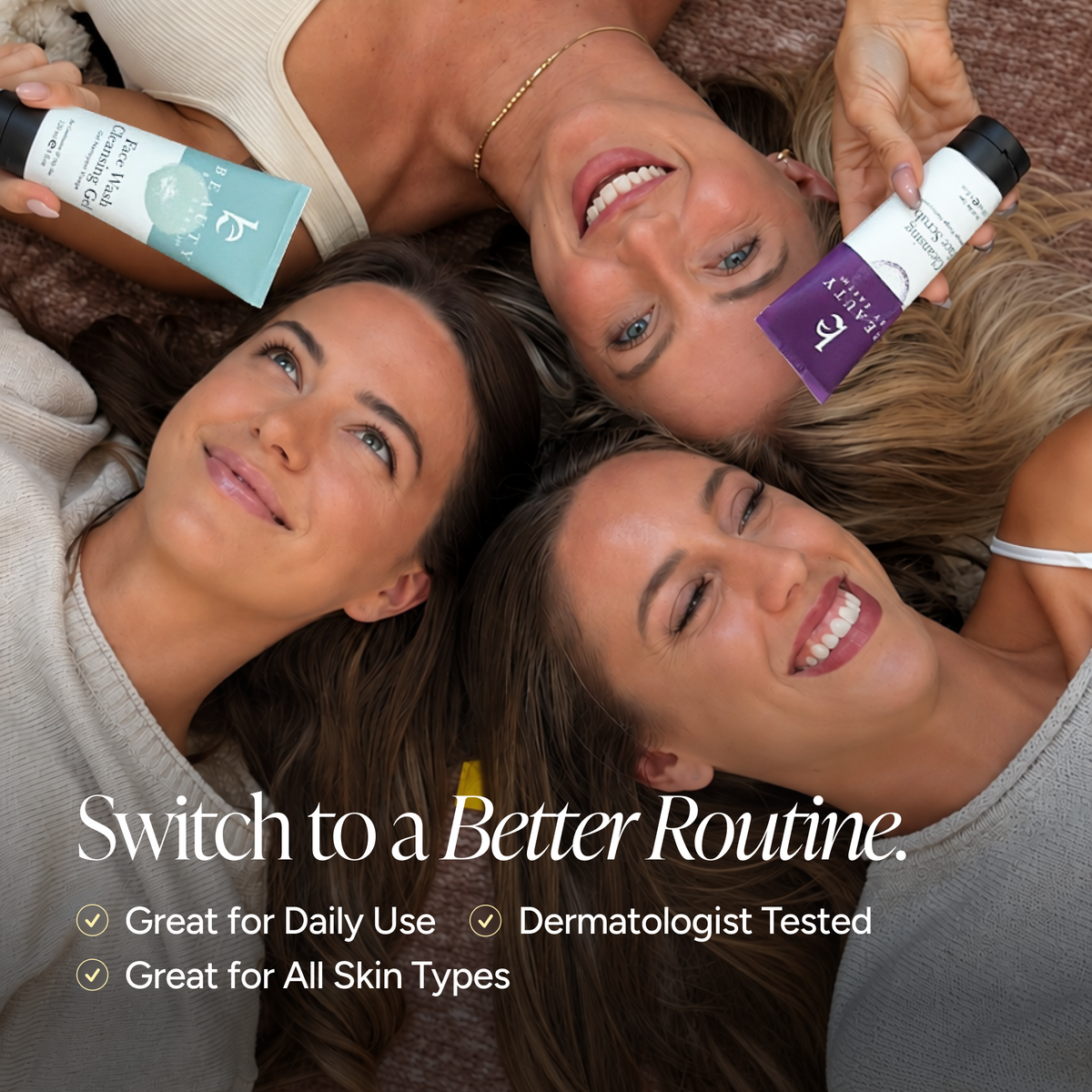 Three women lying down together, each holding a bottle of Beauty By Earth products.