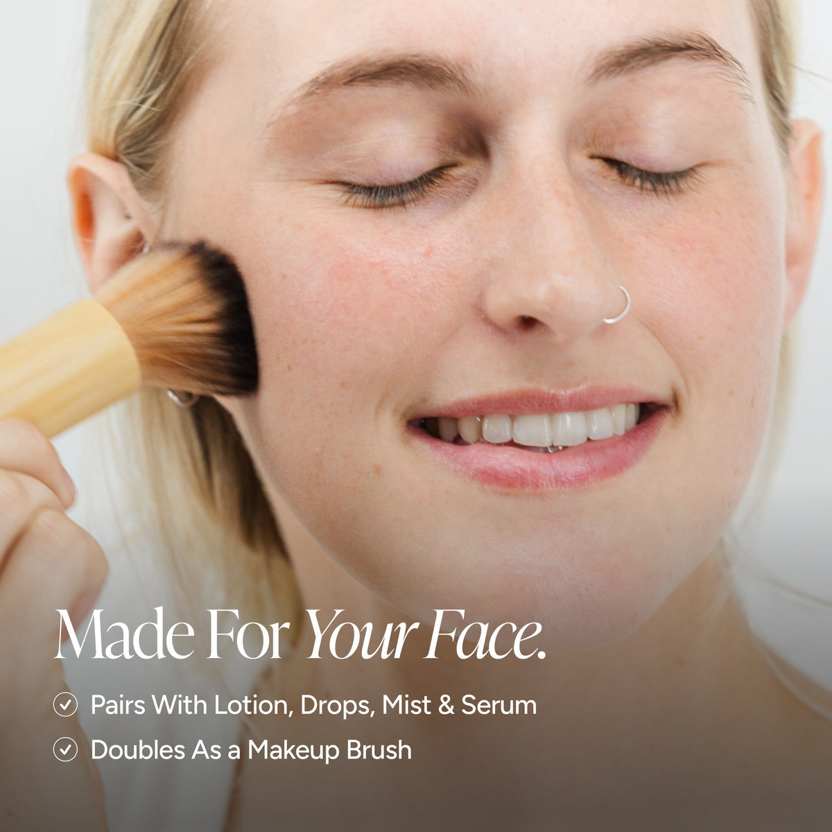 Close-up of a woman applying face self-tanner with a brush on her cheek, with text reading 'Made For Your Face' and bullet points about pairing with lotion, drops, mist & serum and doubling as a makeup brush.