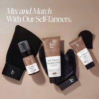 Beauty by Earth self-tanning set arranged on a beige background with the text 'Mix and Match With Our Self-Tanners.' The set includes a black towel, two black mitts, a brown bottle of self-tanner spray, and two brown tubes of self-tanning lotion and free tanner lotion.