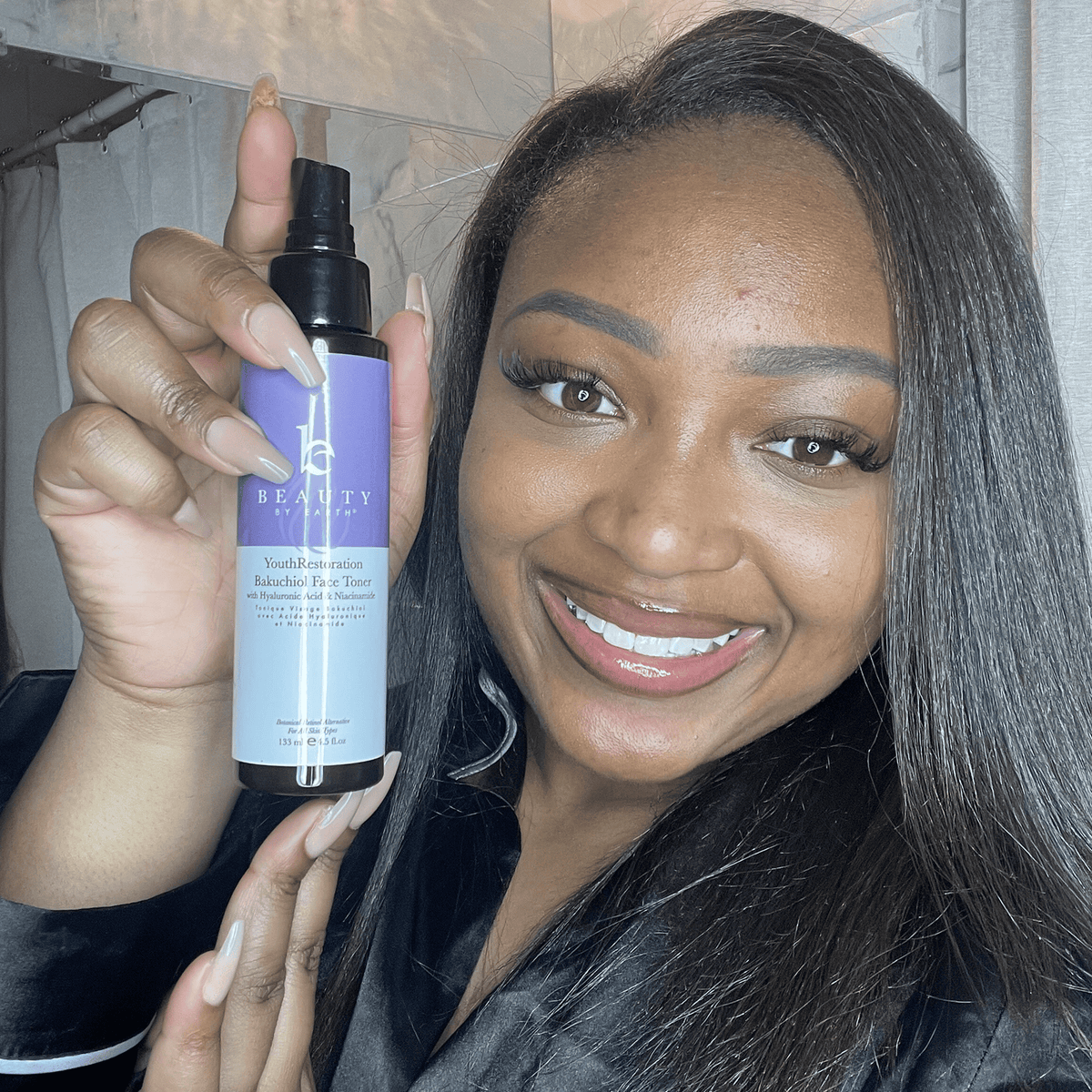 Woman holding a bottle of '100% Beauty' product in a bathroom setting