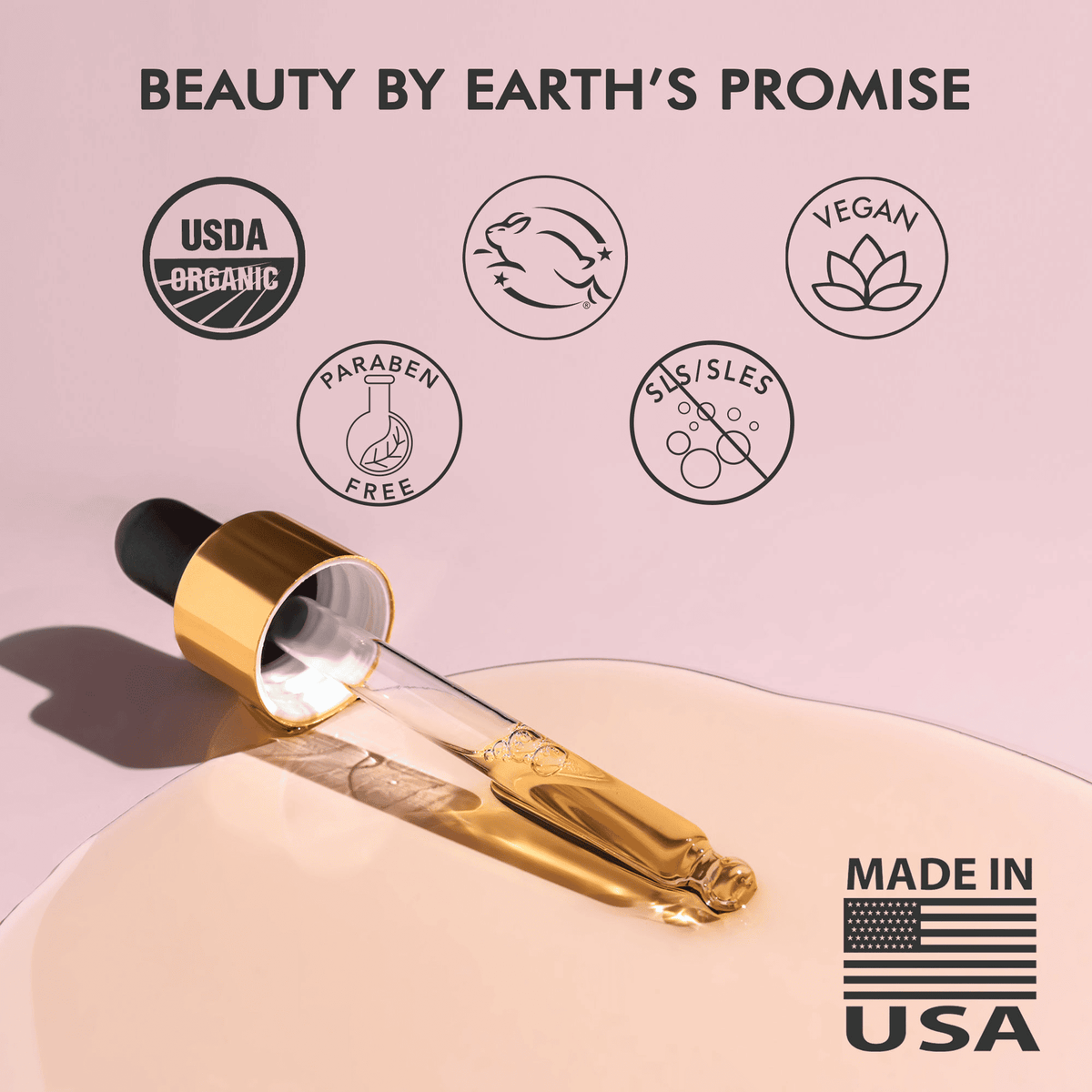 Cosmetic dropper with gold cap and clear liquid on a pink background, featuring 'Beauty by Earth's Promise' branding and certification logos.