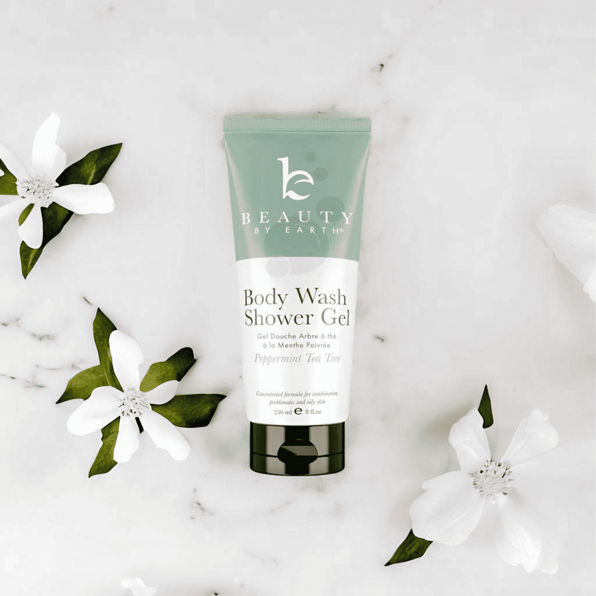 Body wash shower gel peppermint tea tree tube with flowers on a light background