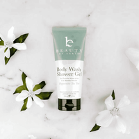 Body wash shower gel peppermint tea tree tube with flowers on a light background