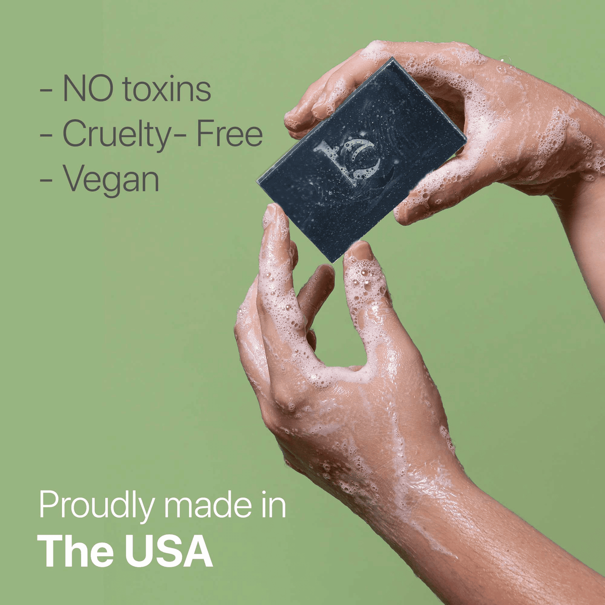 No toxins, cruelty-free, vegan, proudly made in the USA - model holding charcoal bar soap in hands soapy