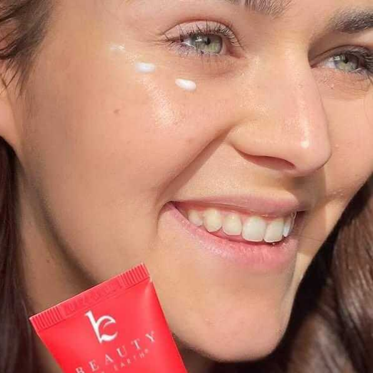Close-up of a woman's face with acoffee bean eye cream under her eye