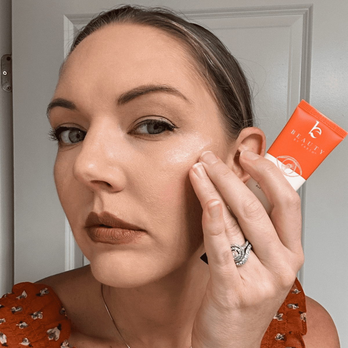 Woman applying coffee bean eye cream under her eye