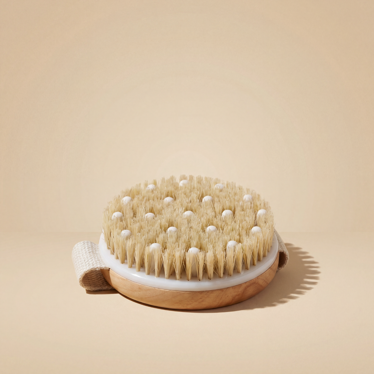 Dry brush with natural bristles on a beige background