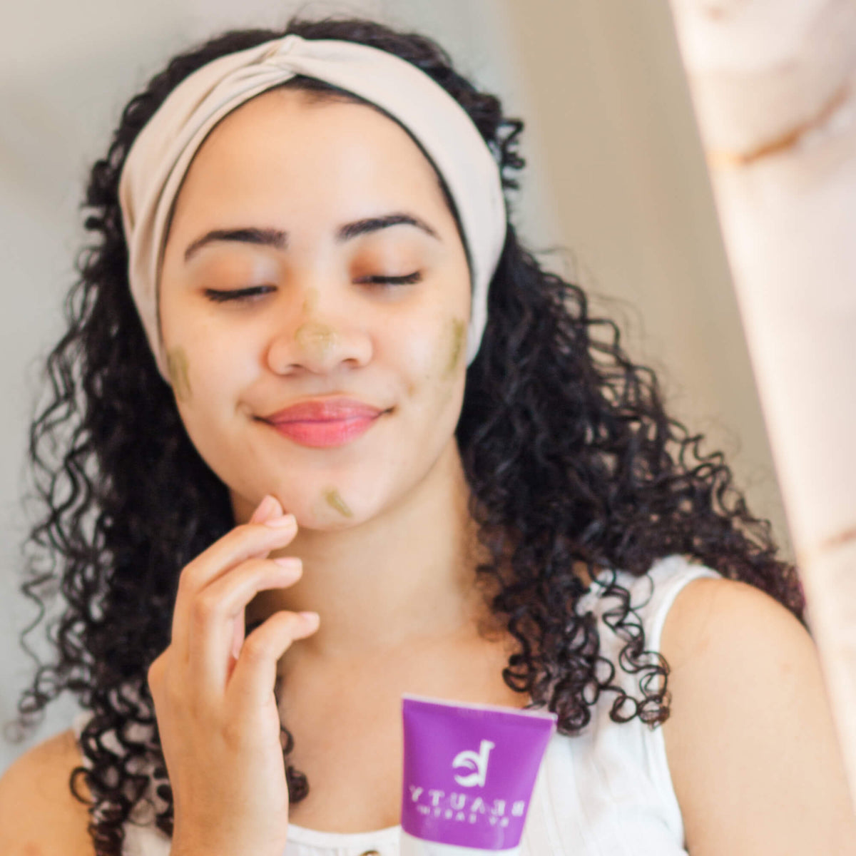 Woman applying a product to her face 