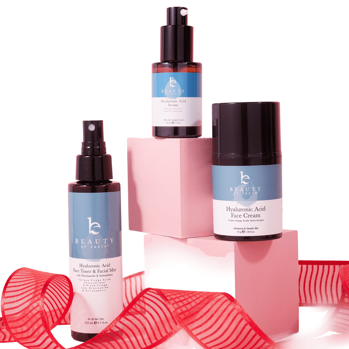 Beauty product set with bottles and a pink box on a white background