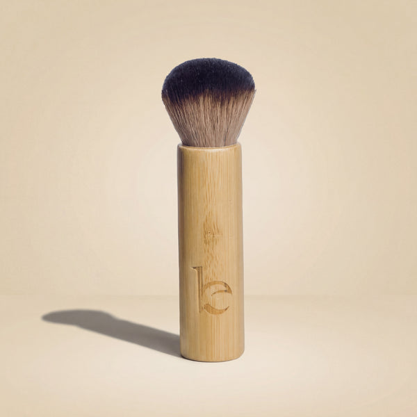 Kabuki facial brush on a beige background