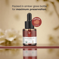 Nail and cuticle oil bottle with dropper labeled 'citrus scent' on a reflective surface.