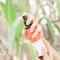 Applying Sea Salt Spray Hair Texturizer outdoors, eco-friendly natural formula, easy spray bottle