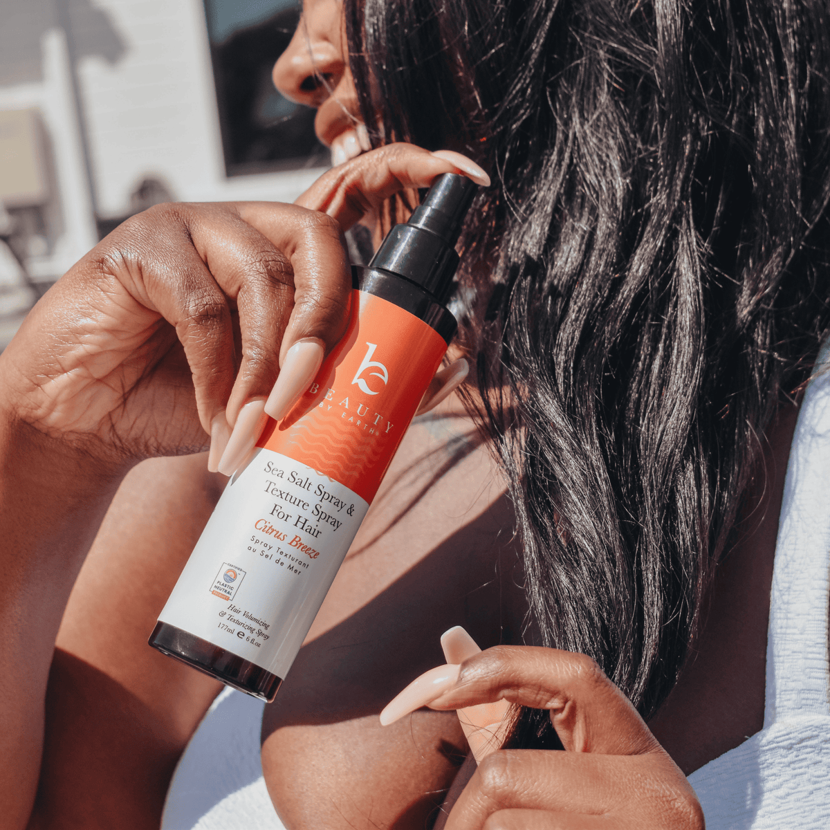 Sea Salt Spray Hair Texturizer being applied for textured, healthy-looking hair in an outdoor setting