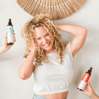 Sea Salt Spray Hair Texturizer held by woman with curly hair, suitable for natural curl enhancement
