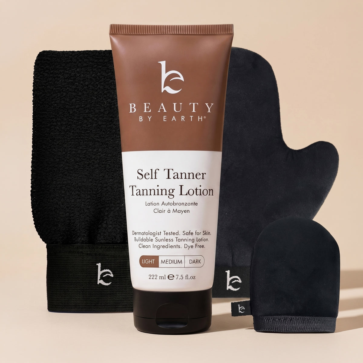 Tube of Beauty by Earth self Tanner tanning lotion with black mitts on a beige background