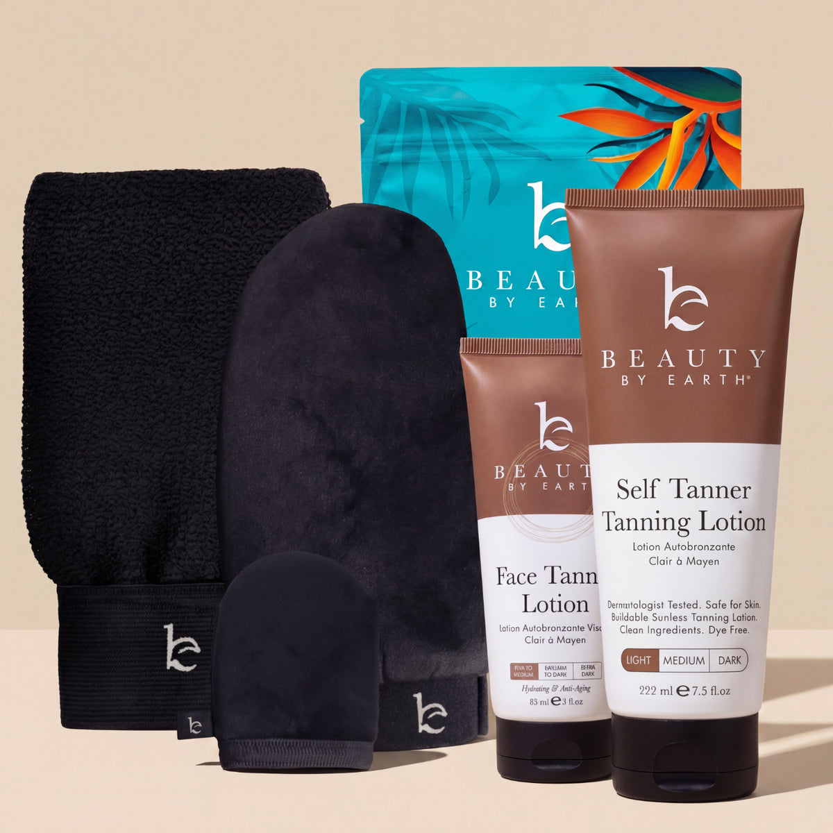 Beauty by Earth self tanner tanning lotion and face lotion tubes, next to the self tanning applicator kit with body, face and exfoliating mitt