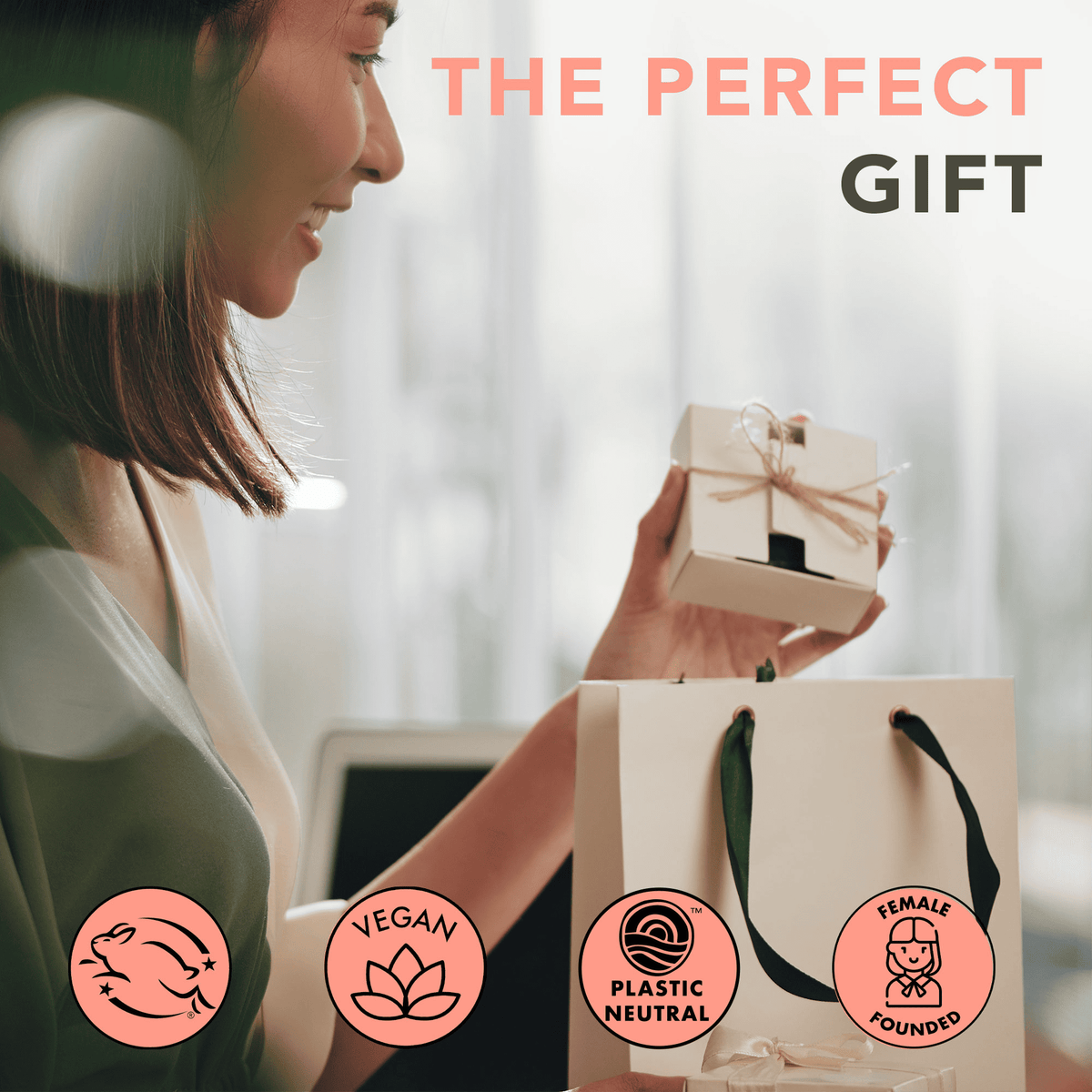 Woman holding a gift box with 'The Perfect Gift' text and ethical certification logos.