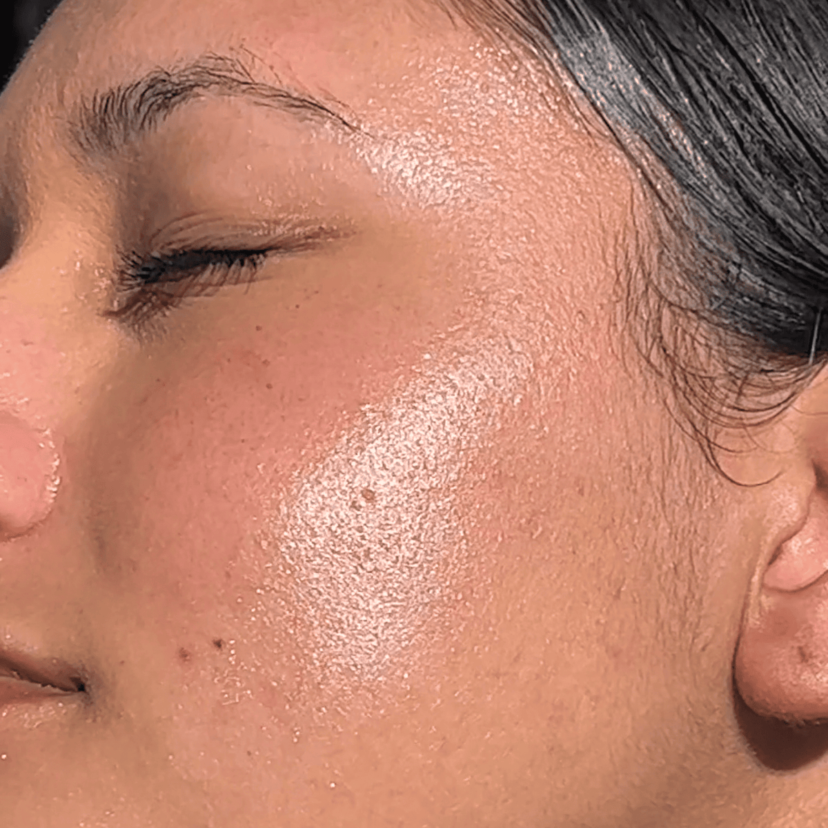 Close-up of a person's face with sun-kissed skin