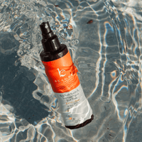  spray bottle on a reflective water surface