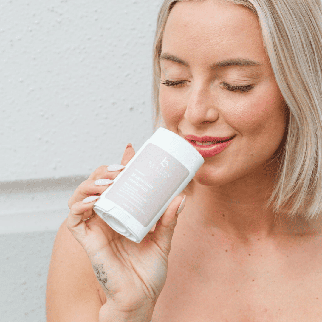 Woman holding a white container with a brand logo against a light background